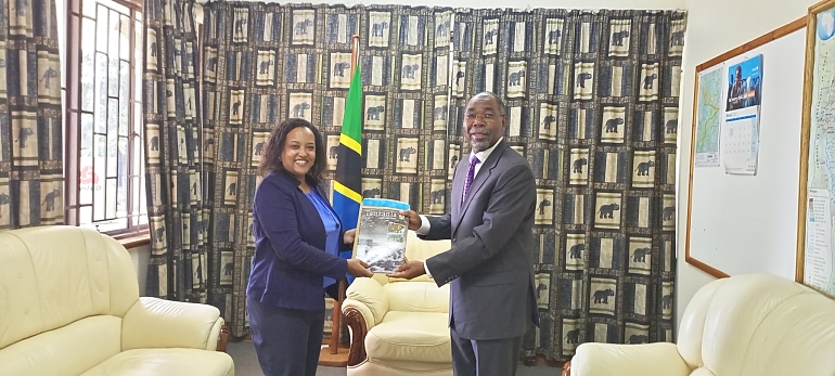 In the picture: H. E. Ambassador Benedicto M. Mashiba, High Commissioner of the United Republic of Tanzania handing over tourism magazines to Ms. Ruth Negash, Chief Executive Officer of COMFWB